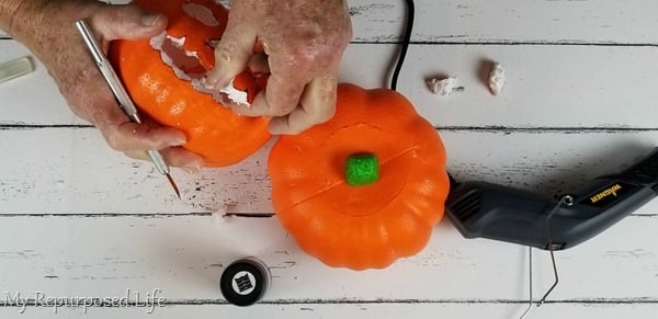 carve jack-o-lantern features in foam pumpkin