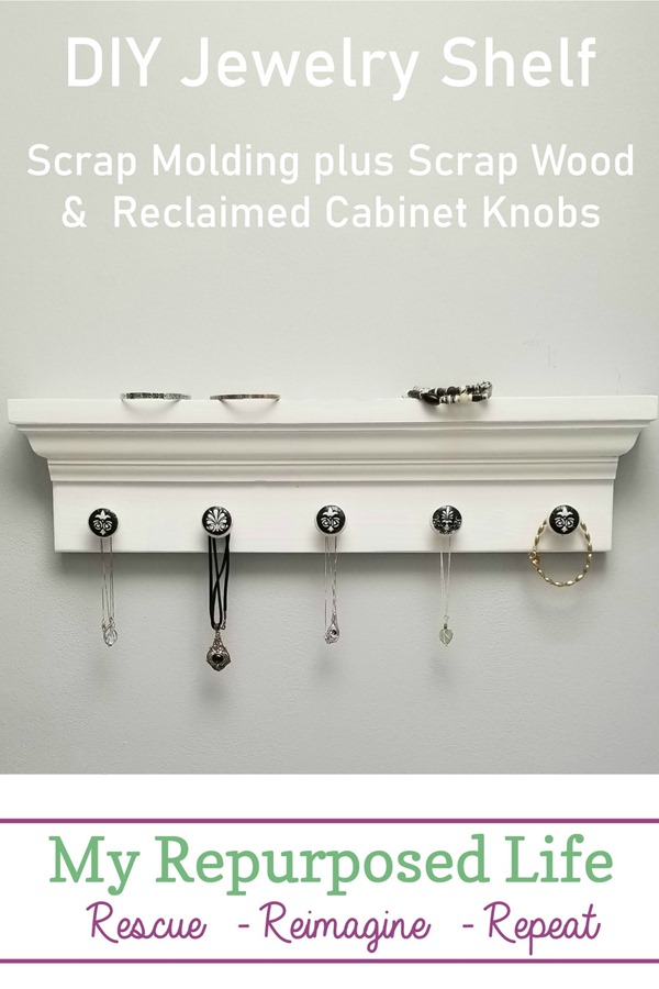 A simple DIY jewelry shelf is made from scrap molding and reclaimed cabinet knobs that have been decoupaged. #MyRepurposedLife #jewelry #shelf #hooks #reclaimed #repurposed #furniture via @repurposedlife