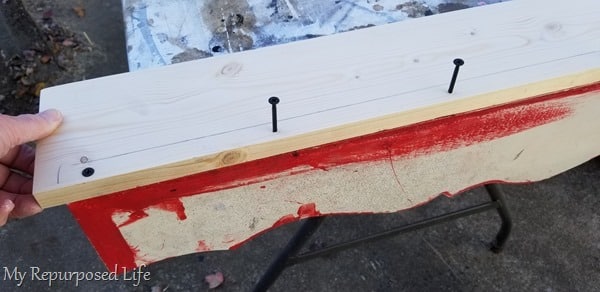 securing screws with shelf resting on table securing screws with shelf resting on table