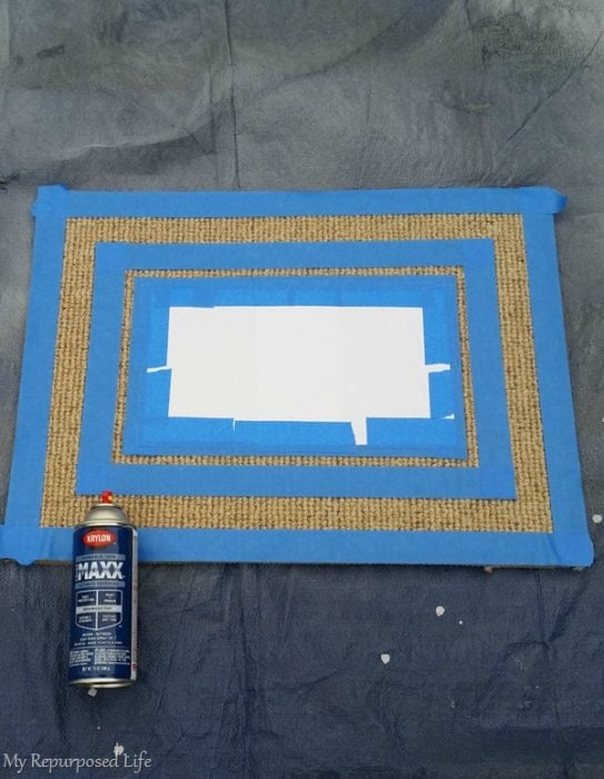 spray paint welcome mat on a tarp