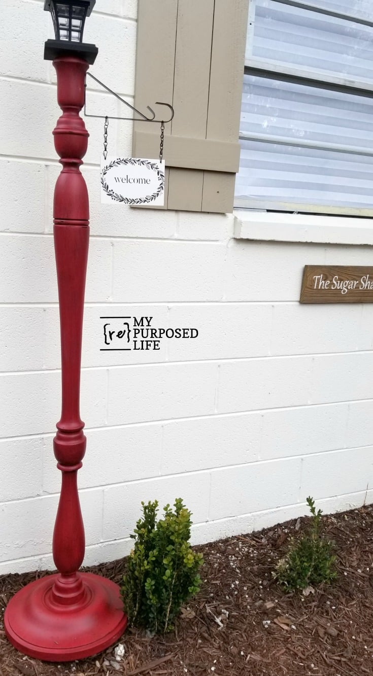 Glazed red is one of my favorite colors, and doesn't it look gorgeous on this welcome porch post? I have the BEST hanging sign bracket hack ever. Don't spend $30 online when you can make one for less than $2. #MyRepurposedLife #repurposed #upcycle #lamp #welcome #porch #post  via @repurposedlife