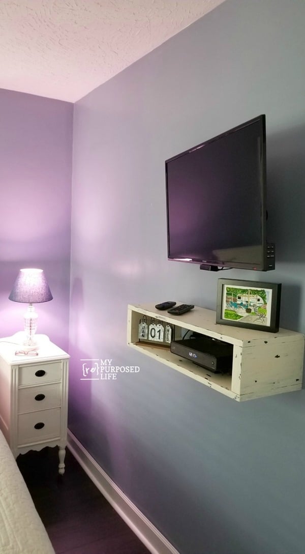 Solving the cord issue when hanging a t.v. on the wall can be quite challenging. I didn't have room for a media center, so I built a floating shelf. All directions included in this tutorial. Bonus: Fishing the wires #MyRepurposedLife #organization #letsgetorganized #bloggerchallenge via @repurposedlife