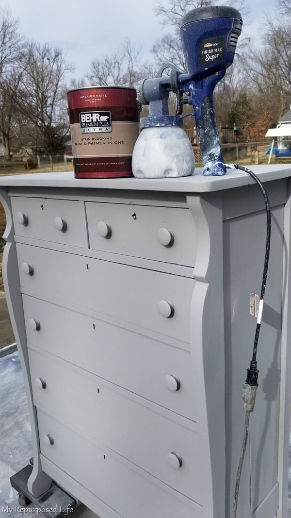 spray antique chest of drawers with topcoat of paint
