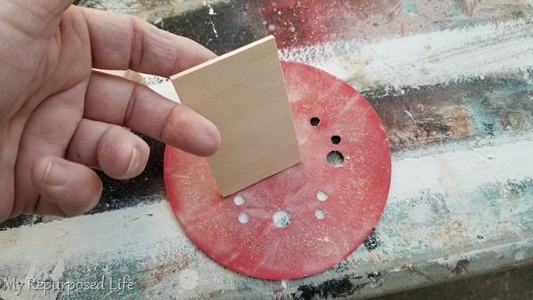 lightly sand wooden discs