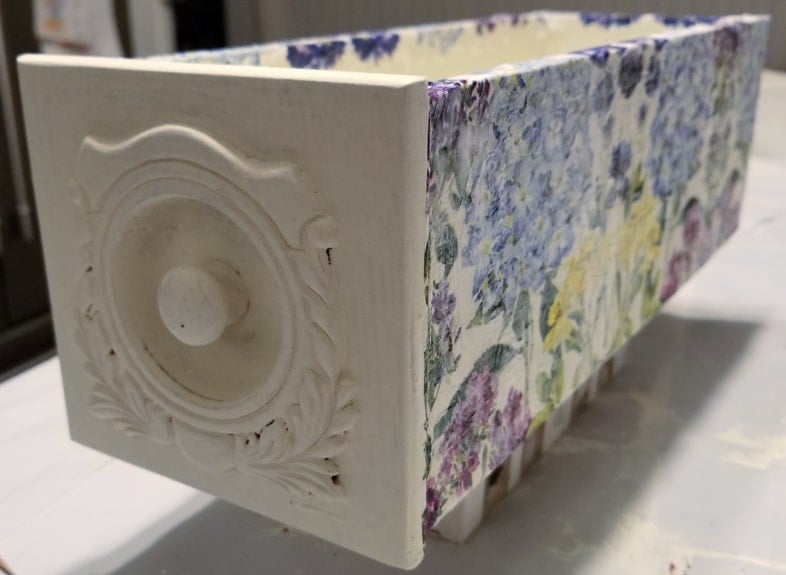 white sewing drawer with napkins decoupaged on it