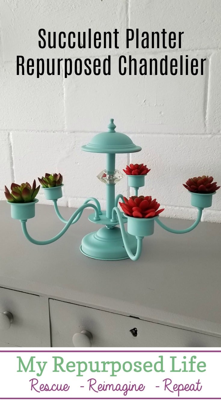 How to make a repurposed chandelier succulent planter that is interchangeable from hanging to setting on a table as a centerpiece. You could easily change this out with candles or potted plants.
Spray painting a brass chandelier really gives you so many options to match your decor. #MyRepurposedLife #repurposed #chandelier #succulent #planter via @repurposedlife