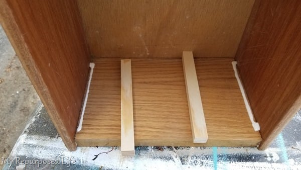 add wood scraps to act as drawer guides
