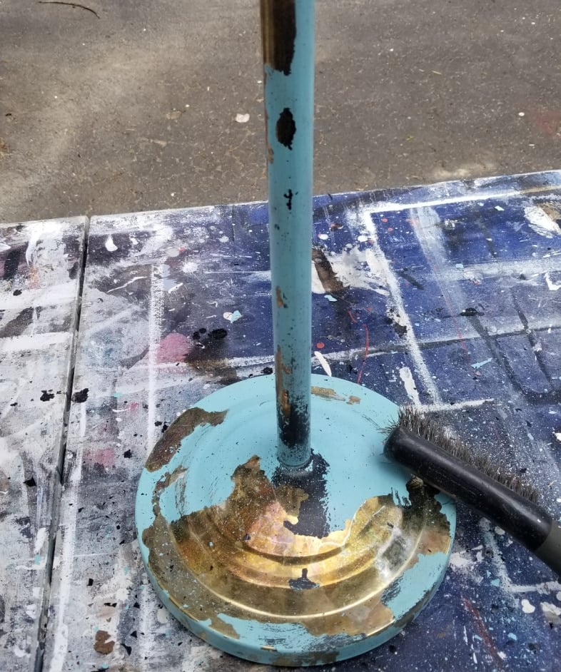 wire brush removing peeling paint from repurposed lamp