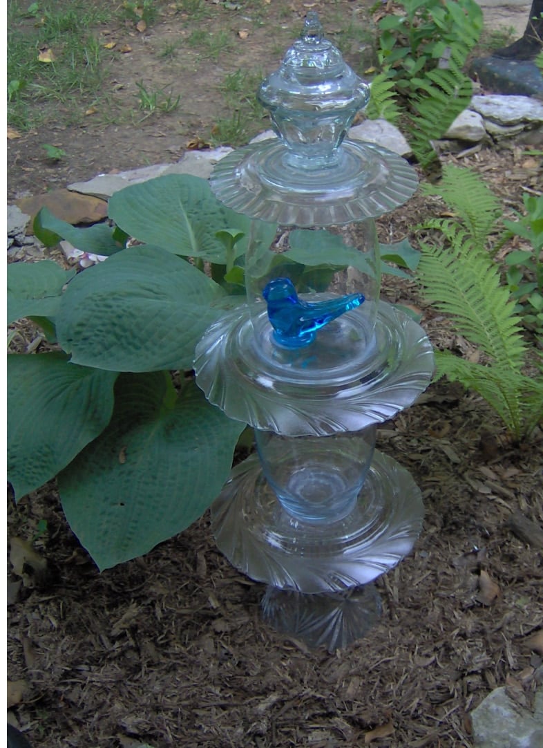 clear glass garden totem with a blue bird figurine