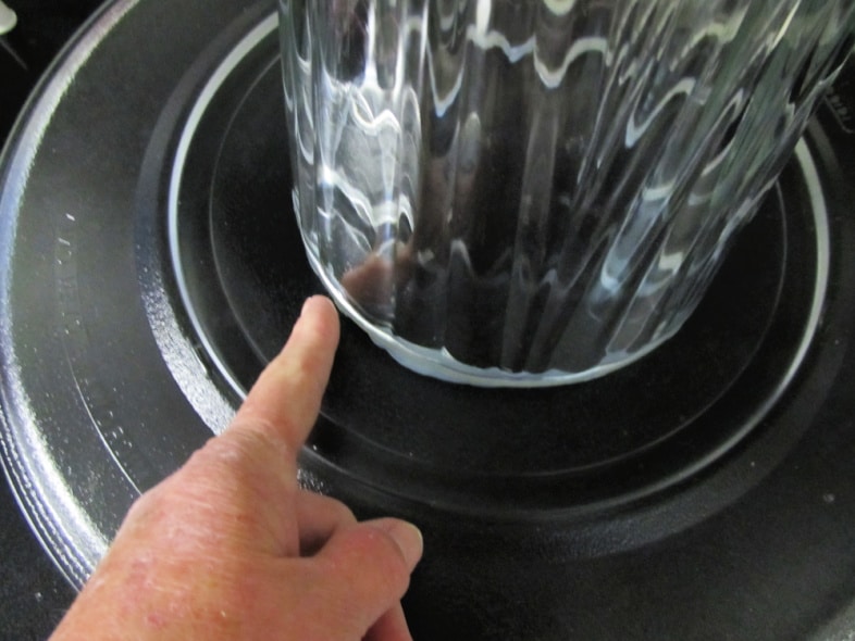 using your finger to wipe away excess adhesive
