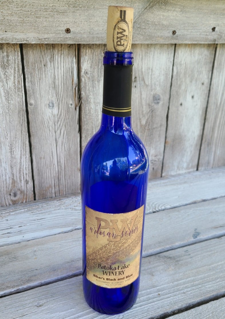 blue wine bottle with cork and label