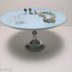 plate stand with vintage jewelry