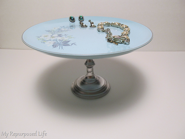 plate stand with vintage jewelry