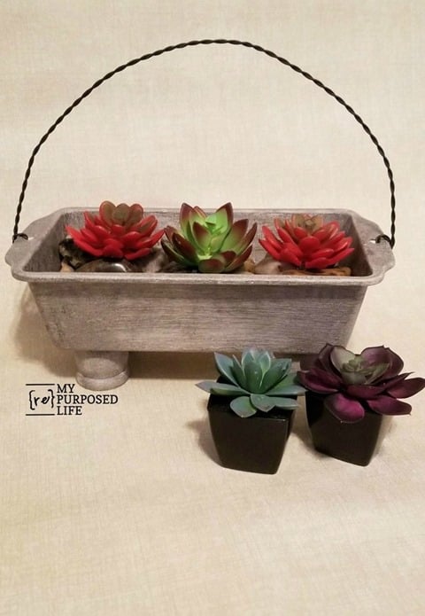 How to make a loaf pan planter for succulents and add a twisted wire handle. Tips on making a twisted wire handle with your cordless drill. Video tutorial for wire handle and picture tutorial for loaf pan planter. #MyRepurposedLife #repurposed #loaf #pan #planter via @repurposedlife
