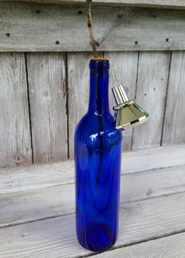 twig in wine bottle moving fairy lights around