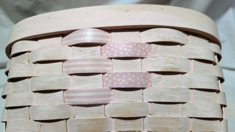 adding washi tape to a wicker basket