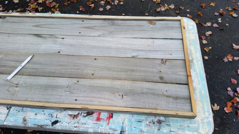 framing a rustic sign with fence boards