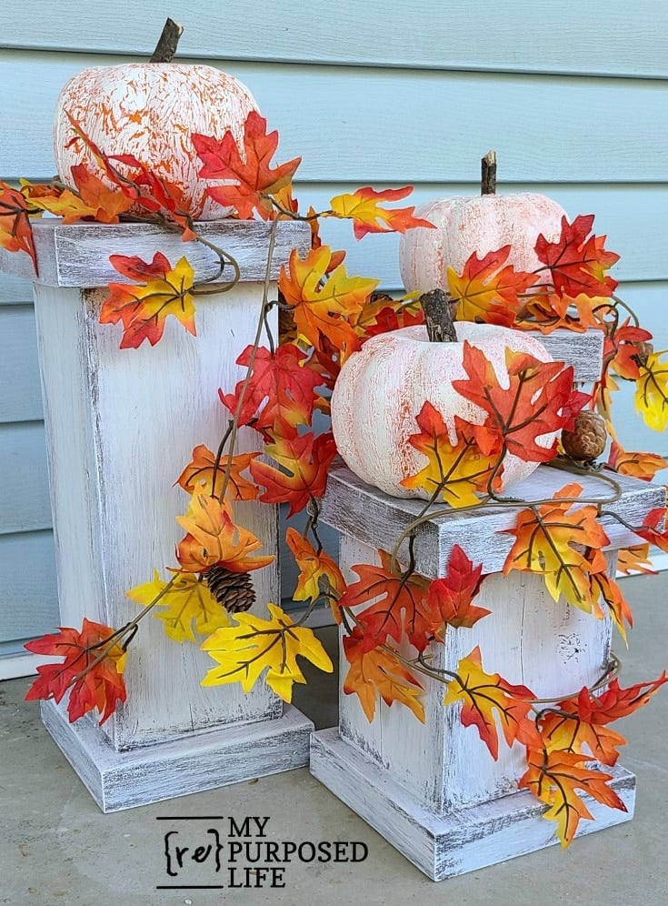 fall decor resting atop chunky plant pedestals