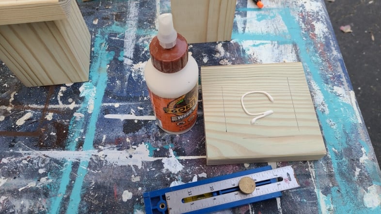 gorilla wood glue spread on a square board