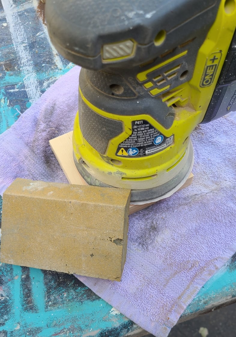 sander atop small square board