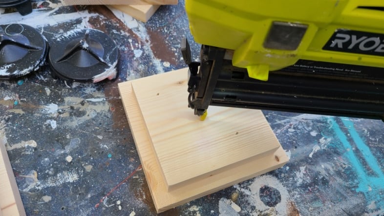 nail gun attaching two square boards
