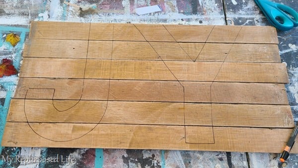 trace joy letters onto reclaimed wood