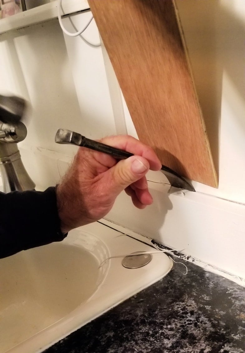 pry bar removing board and batten
