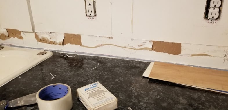 backsplash wall with glue remnants