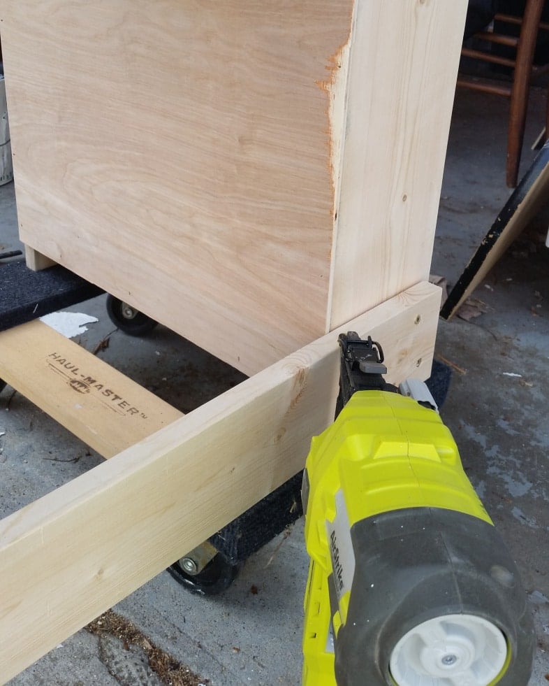 nailgun adding thin plywood to back of bookshelf
