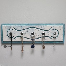 wooden jewelry organizer holding necklaces