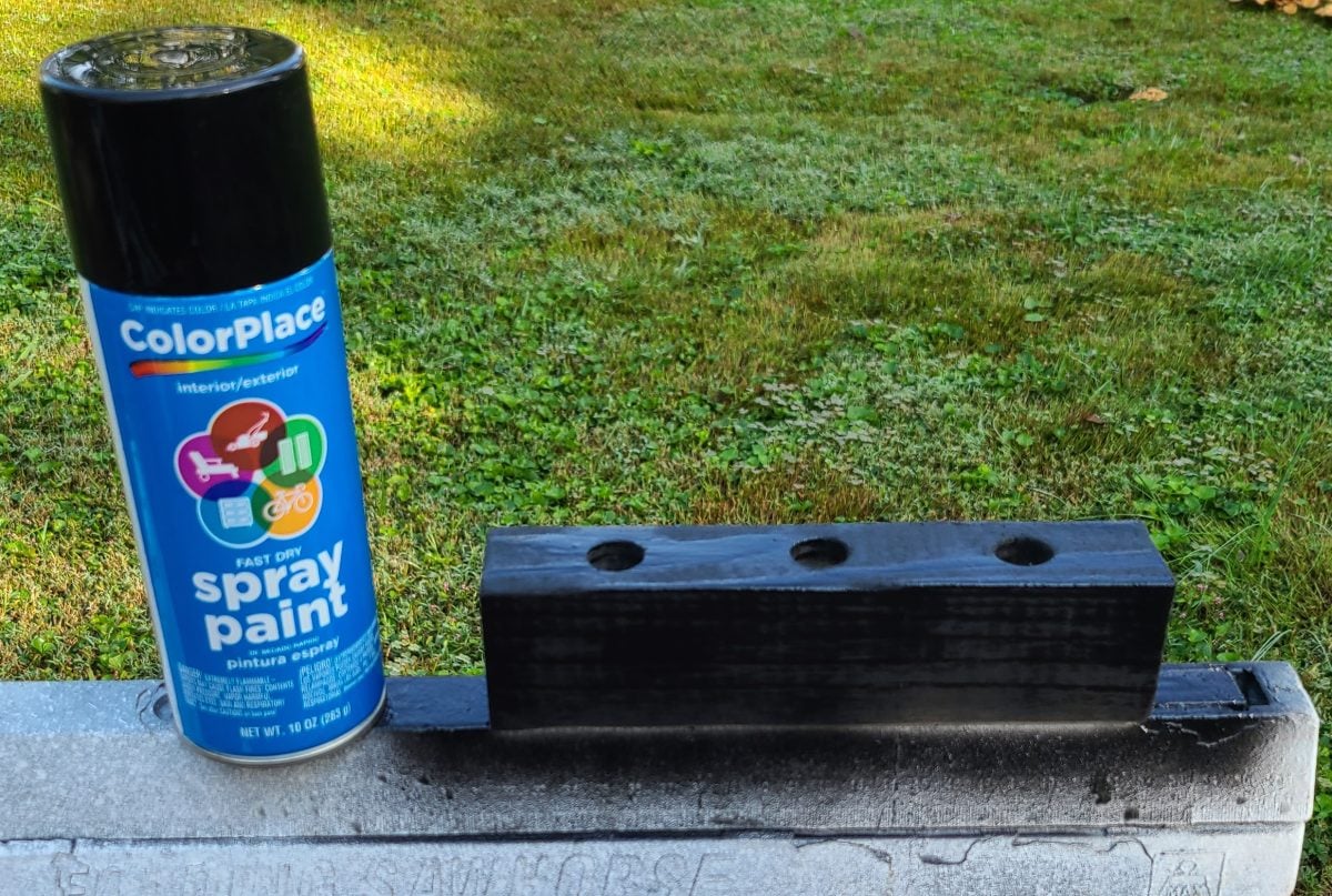 spray paint scrap wood to hold solar lights