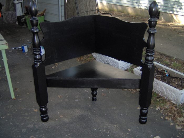 black corner bench made from a heaboard