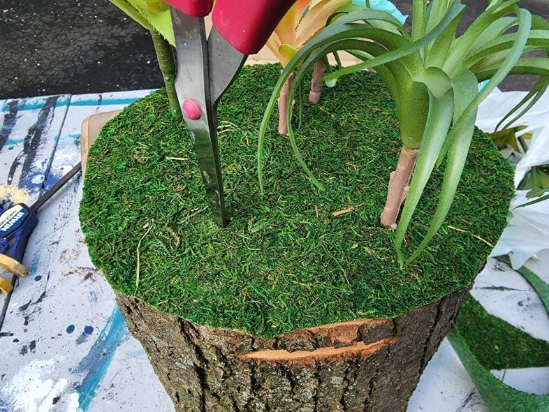 applying moss to fairy garden stump