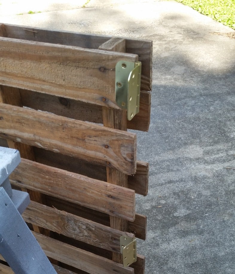 closeup of door hinges on pallet bar