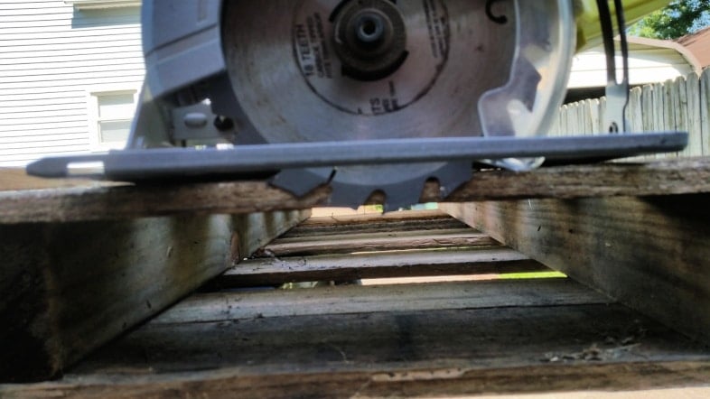 a circular saw blade ready to cut pallet in half