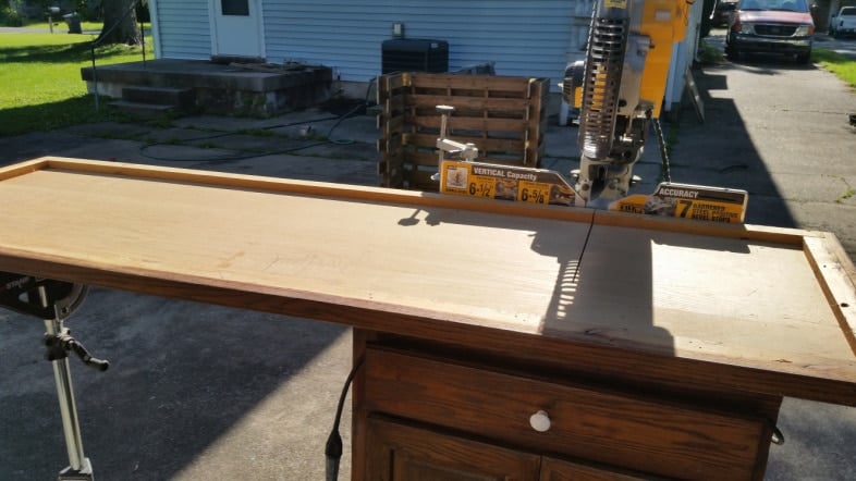 sliding compound miter saw cutting long board