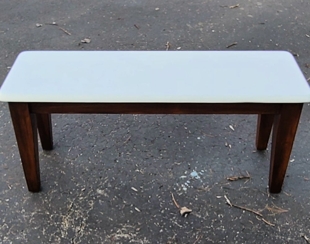 two toned wooden bench with a white seat
