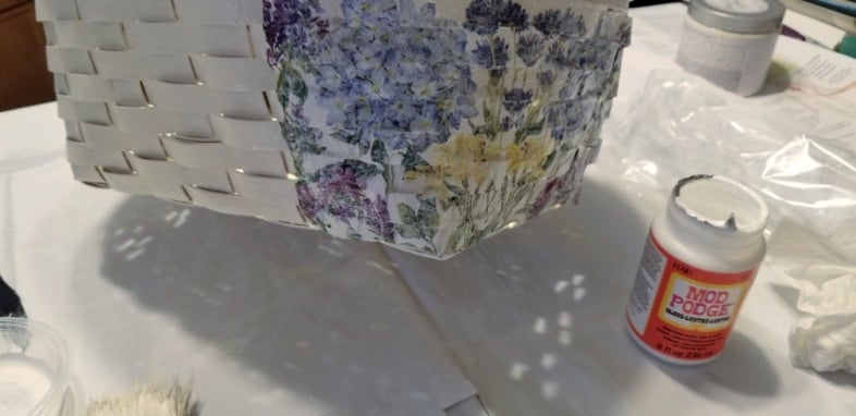 woven basket halfway finished with mod podge