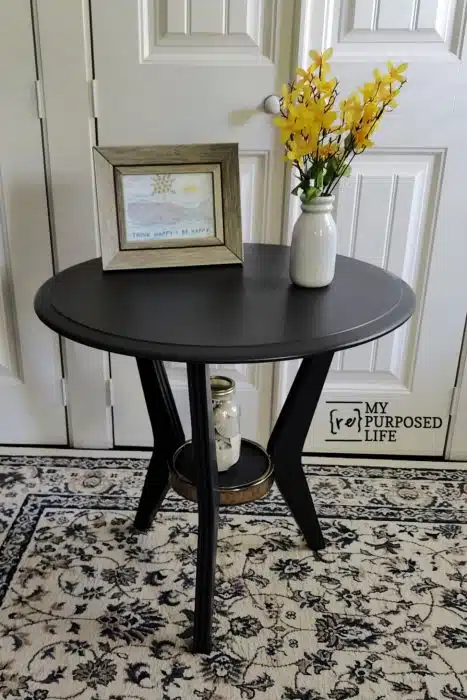 dark gray round three legged table