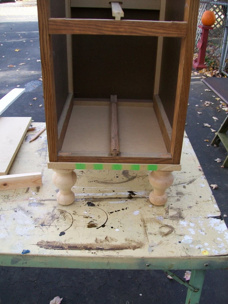 bottom drawer section with a base and legs