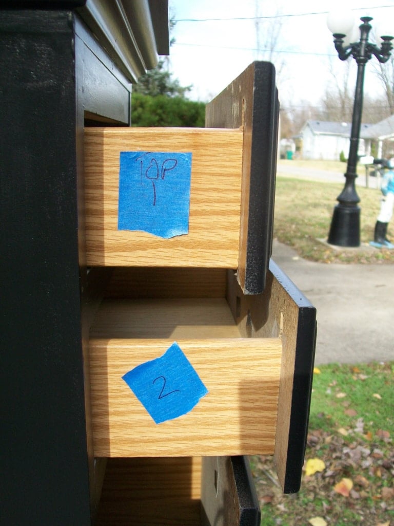 side view of chest with drawers open, painter's tape with numbers