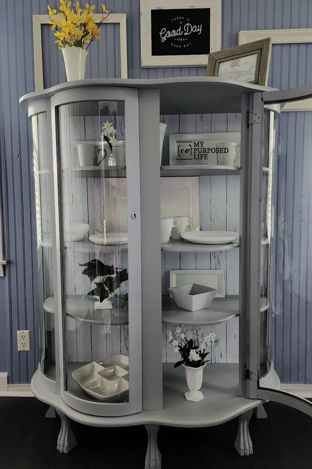 gray antique china cabinet with white dishes