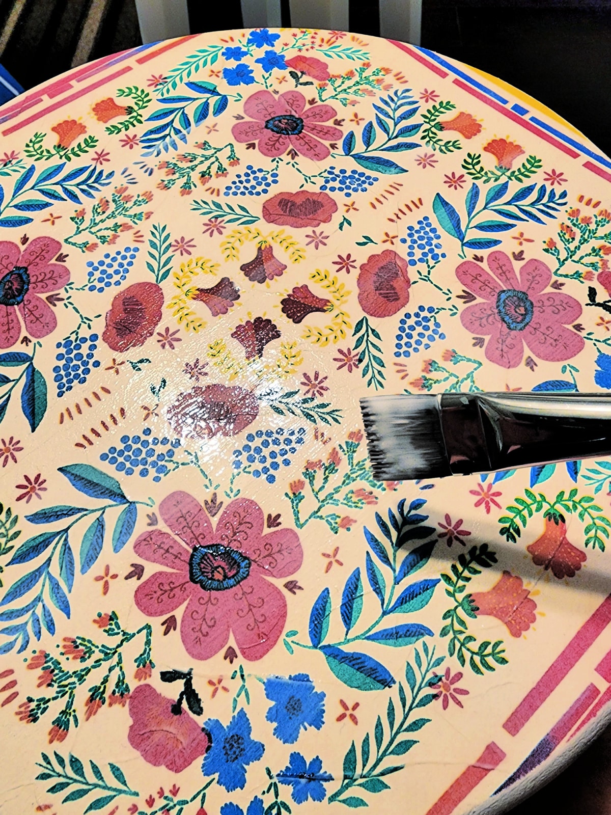 apply several coats of mod podge to seal the decoupaged napkin