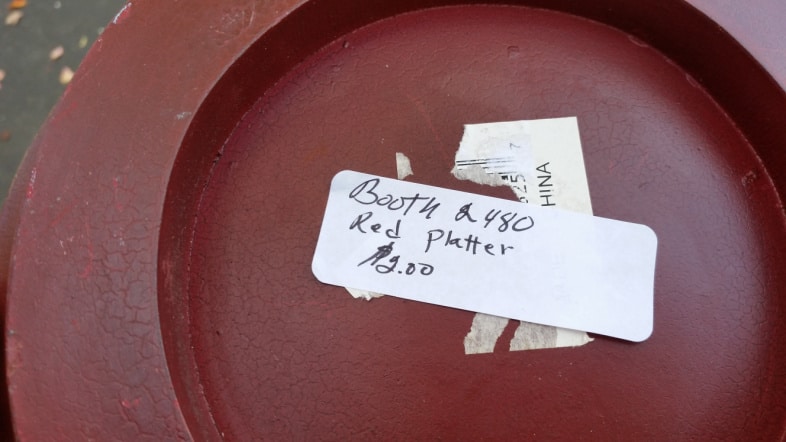 white stickers on the bottom of a thrift store platter