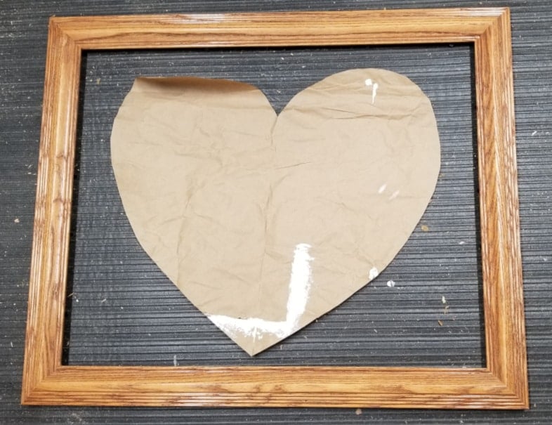 paper heart in wooden picture frame