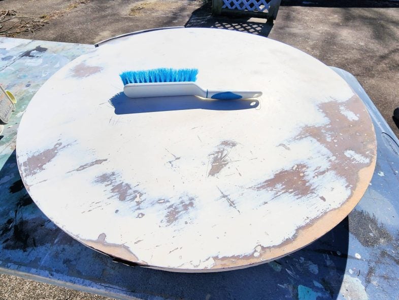 drum table with dust brush on top of it