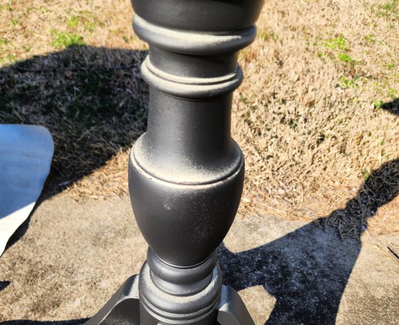 turned table base with first coat of black paint