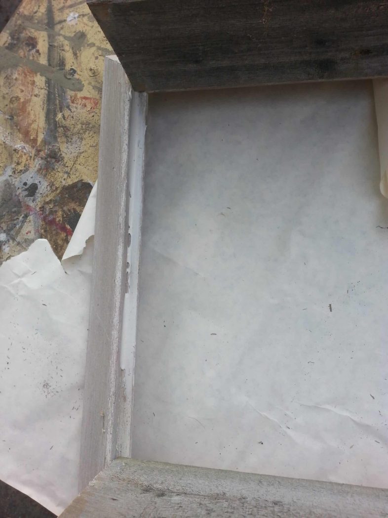 liquid nails spread on rustic wood