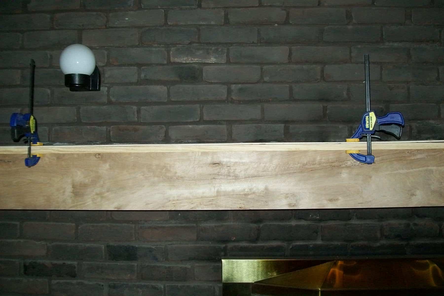 clamp boards to make faux wood mantel