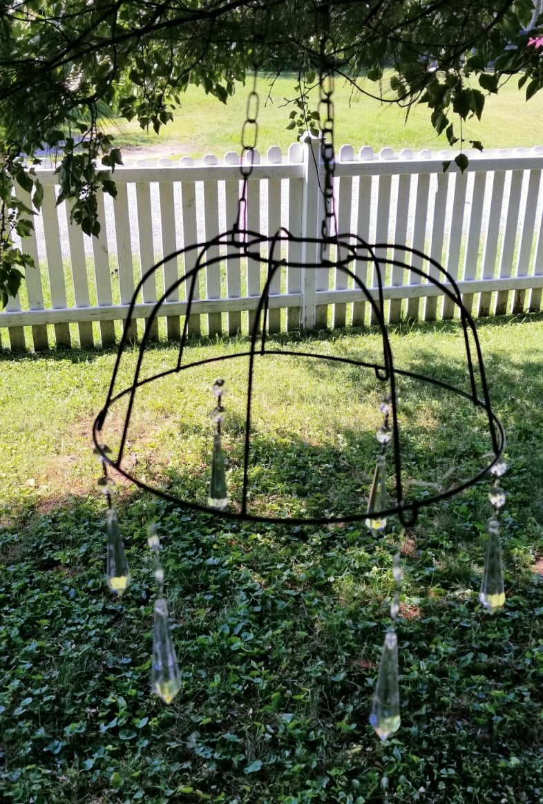 upside down moss basket with glass prisms hanging from it